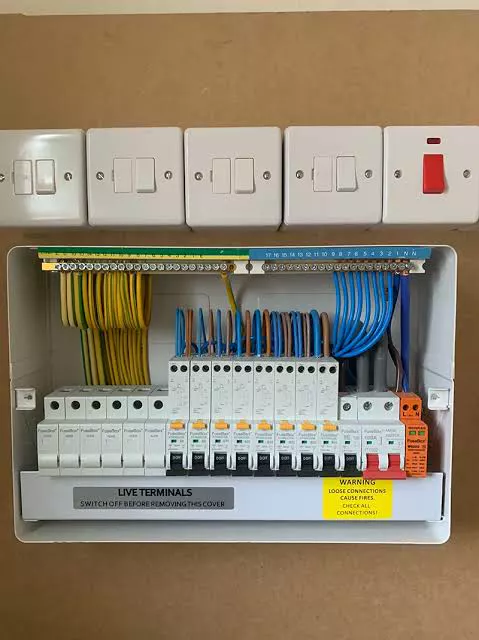 A consumer unit fitted beneath a row of isolator switches