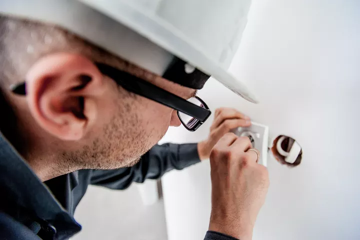 An electrician fitting a new wall socket